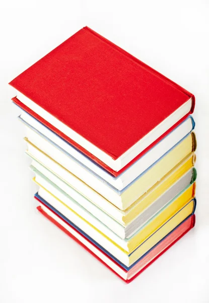 Kleurrijke gestapelde boeken op neutrale achtergrond — Stockfoto