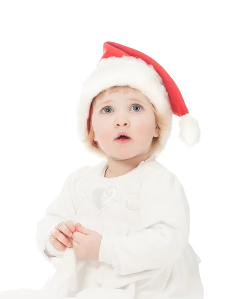 在圣诞老人的帽子的女孩 免版税图库照片