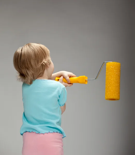 Child with a big paint roller — Stock Photo, Image