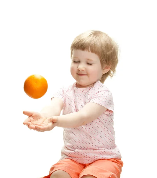 Girl playing with orange — Stock Photo, Image