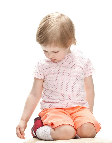 Child sitting and looking down — Stock Photo, Image