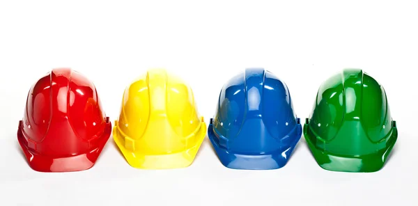 色とりどりの建設 hardhats — ストック写真