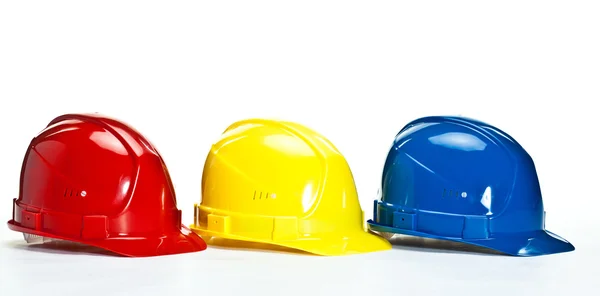 色とりどりの建設 hardhats — ストック写真