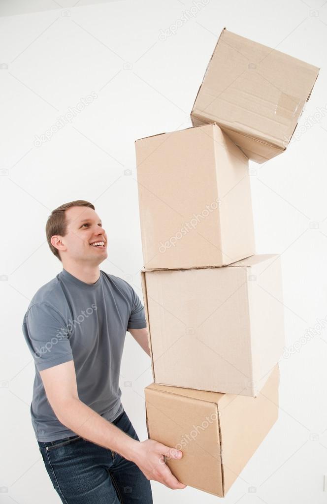 Man carrying many cardboard boxes