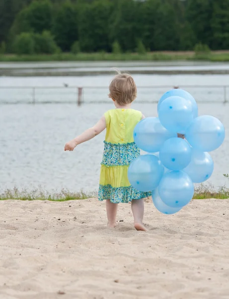 Girl with bunch of balloons — Stock Photo, Image