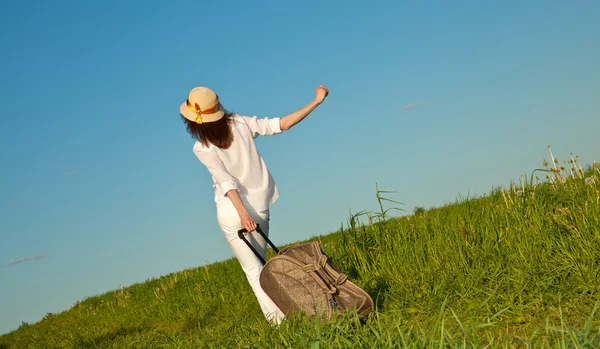Ttraveller walking with a suitcase — Stock Photo, Image