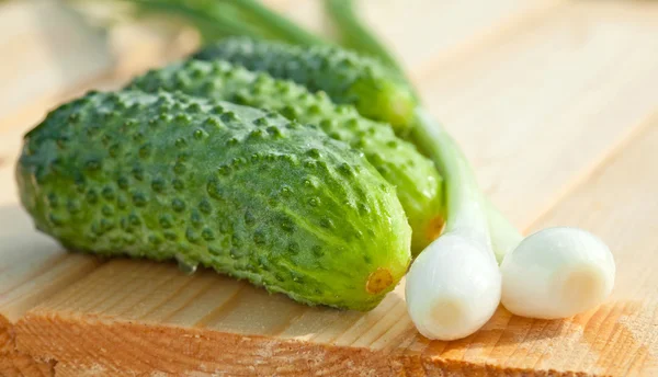 Fresh cucumbers and onion — Stock Photo, Image