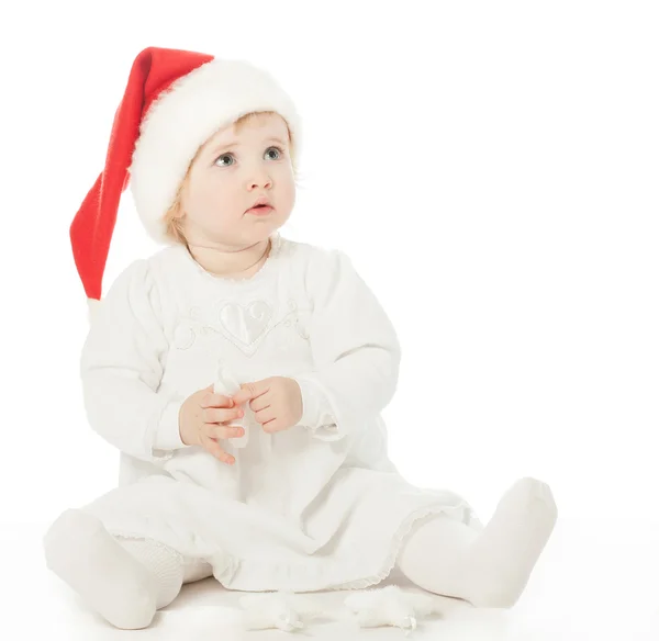 Girl in Santa's hat playing — Stock Photo, Image