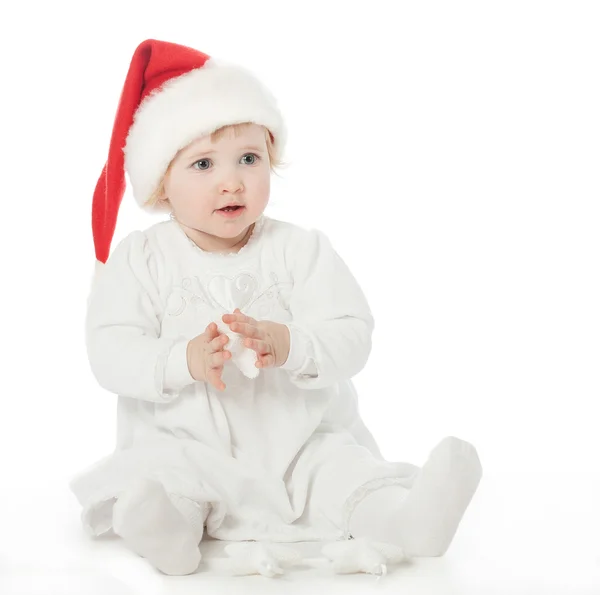 Girl in Santa's hat playing — Stock Photo, Image