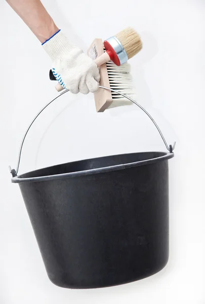 Painter holding paintbrushes and bucket — Stock Photo, Image