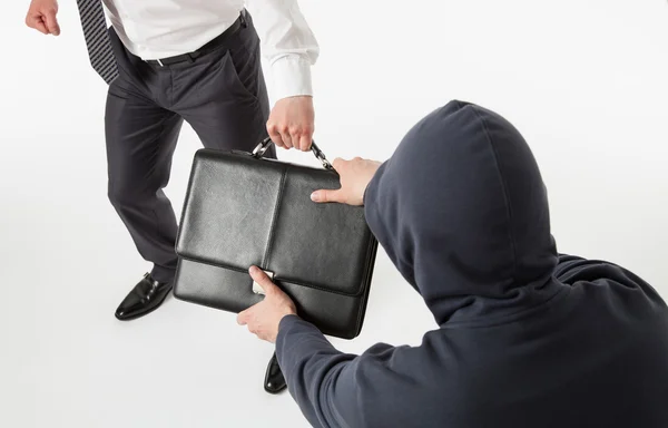 Man take away a businessman's briefcase — Stock Photo, Image