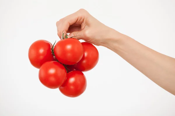 Hand holding a bunch of tomatoes — Stock Photo, Image