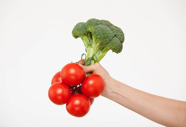 Hand holding tomatoes, broccoli and pepper — Stock Photo, Image