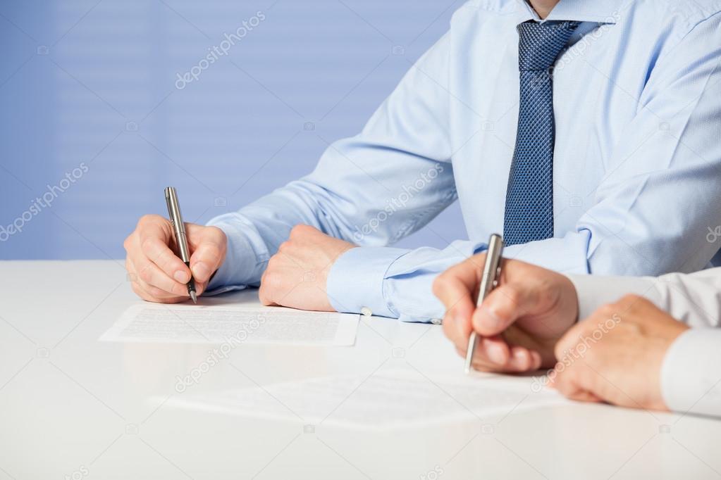 Businessmen signing a contract