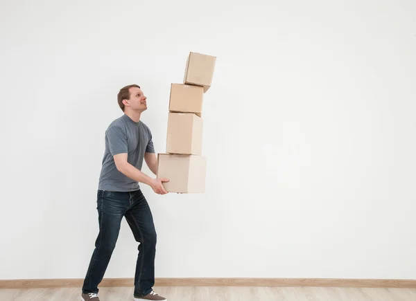 Man carrying many cardboard boxes — Stock Photo, Image