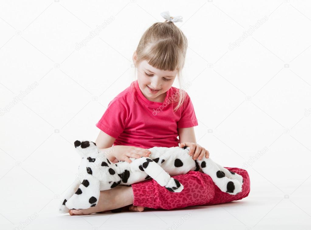 Girl playing with plush toy