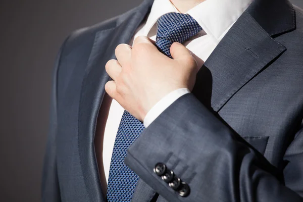 Businessman adjusting his tie — Stock Photo, Image