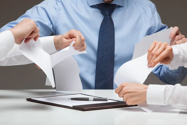 Businesspeople cruelly tearing documents — Stock Photo, Image