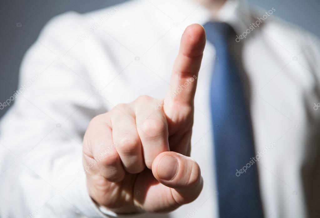 Businessman touching with index finger something