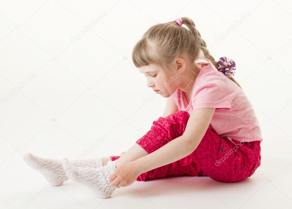 Pretty little girl trying on sock