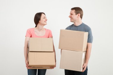 Man and woman holding cardboard boxes clipart