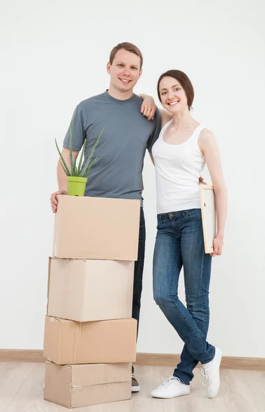 Man and woman standing near cardboard boxes — Stock Photo, Image