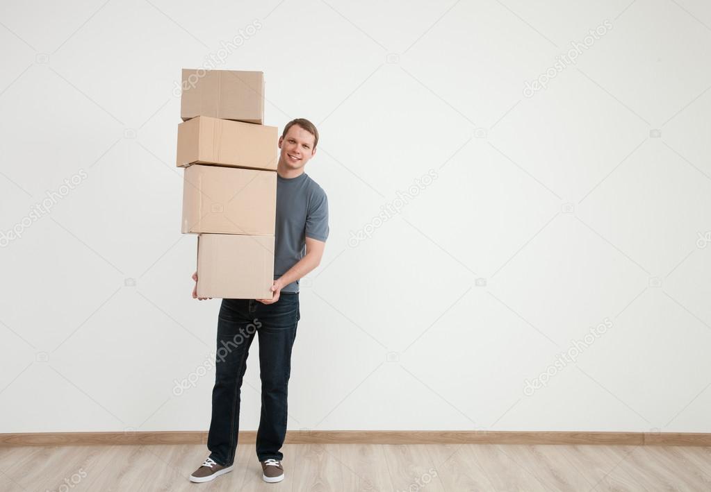 Man carrying many boxes