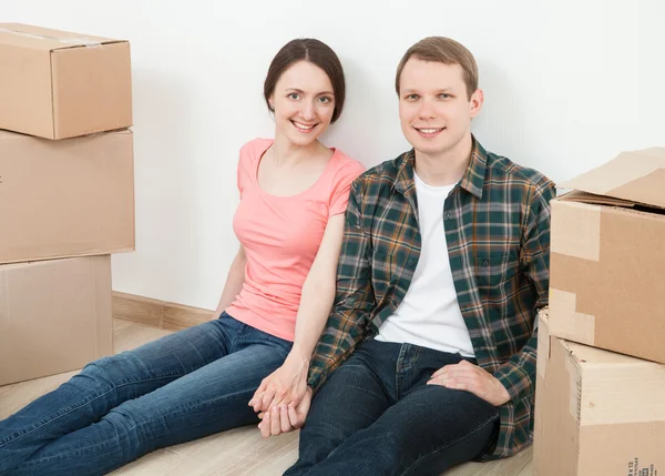 Happy young man and woman sitting — Stock Photo, Image