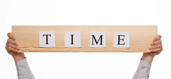 Businessman holding a wooden plate  "Time" — Stock Photo, Image