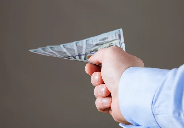Businessman's hand reaching out dollars — Stock Photo, Image