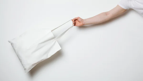 Male hand with cotton eco bag — Stock Photo, Image