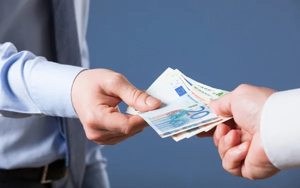 Businessman's  hands exchanging euro — Stock Photo, Image