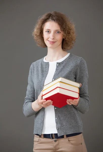 Estudante menina segurando livros — Fotografia de Stock