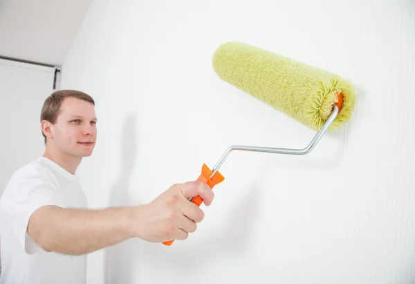 Man painting with roller — Stock Photo, Image