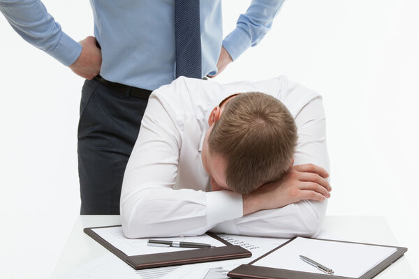 tired businessman sitting at table