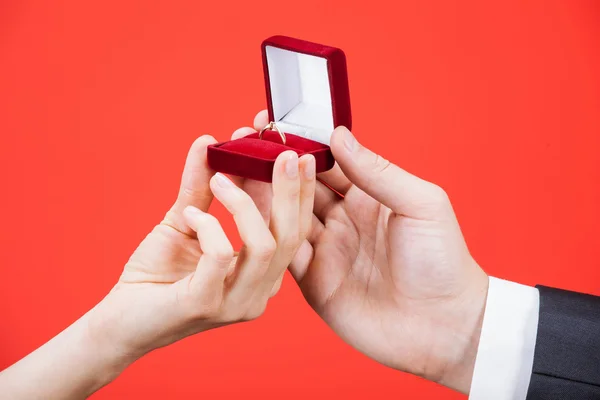 Man presents golden ring for young woman — Stock Photo, Image