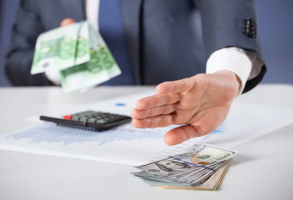 Businessman refusing dollars and choosing euro Stock Picture