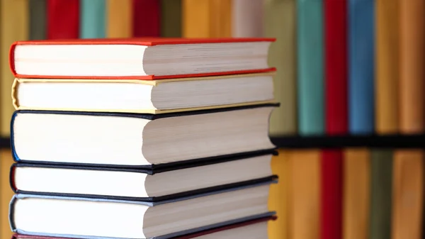 Stacked books and bookshelves — Stock Photo, Image