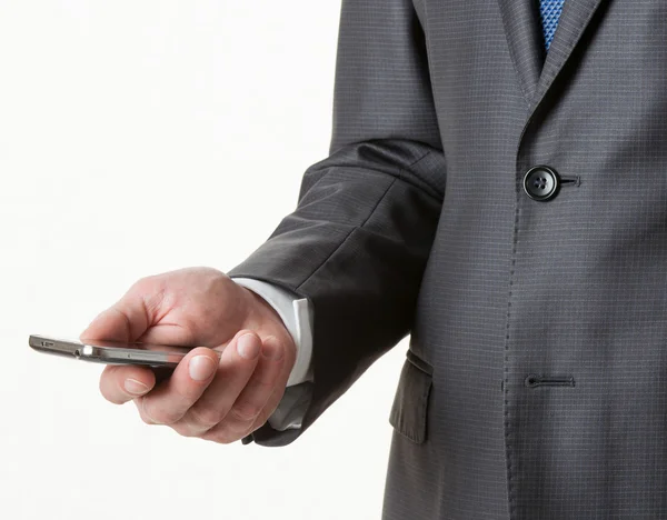 Empresário irreconhecível segurando um celular — Fotografia de Stock