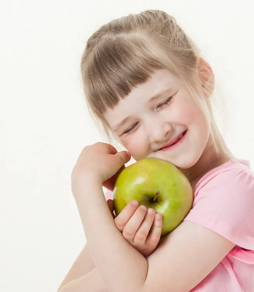 Happy little girl holding a apple — Stock Photo, Image