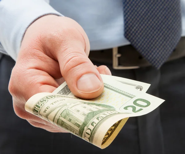 Unrecognizable businessman holding twenty dollars — Stock Photo, Image