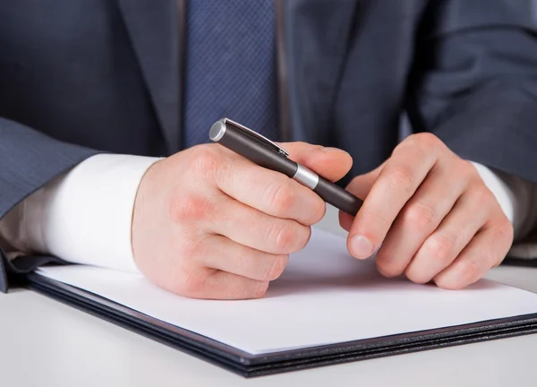 Businessman with pen over document — Stock Photo, Image