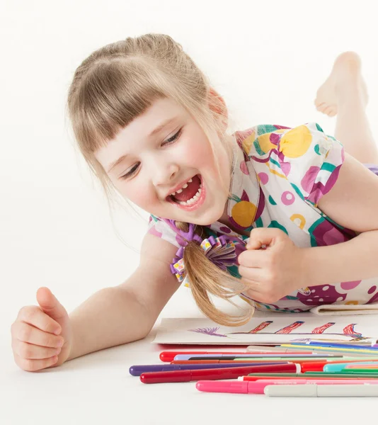 Маленькая девочка выбирает фломастерную ручку — стоковое фото
