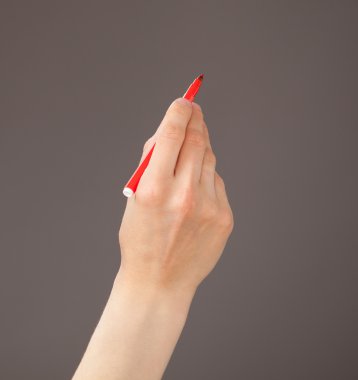 Kırmızı keçeli kalem tutan el 