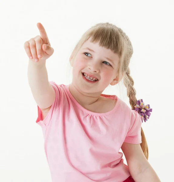 Smiling little girl indicating something — Stock Photo, Image