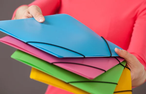 Young woman holding bright folders — Stock Photo, Image