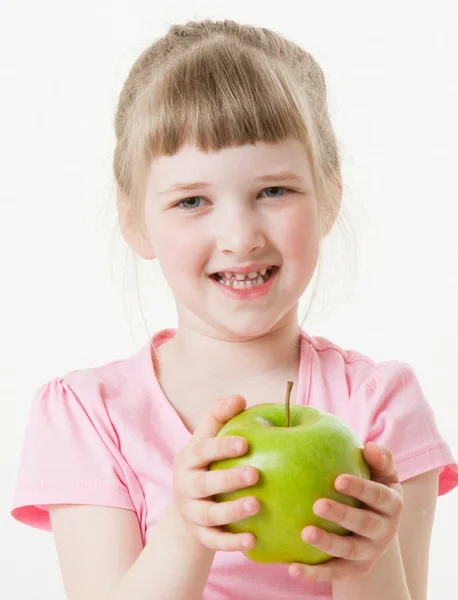Little girl holding a green apple Royalty Free Stock Images