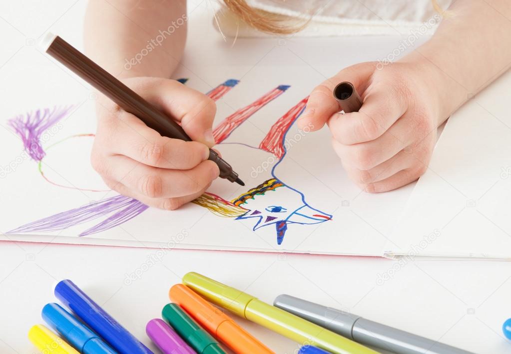 little girl drawing a narwhal