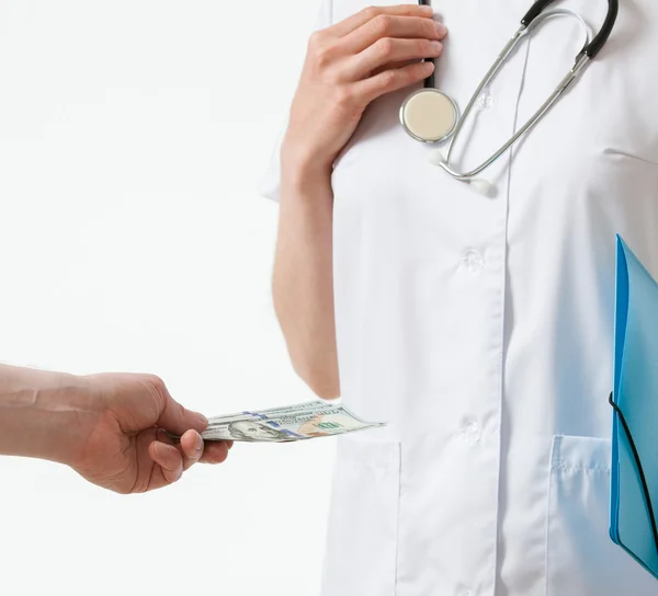 Patient's hand giving a bribe doctor — Stock Photo, Image
