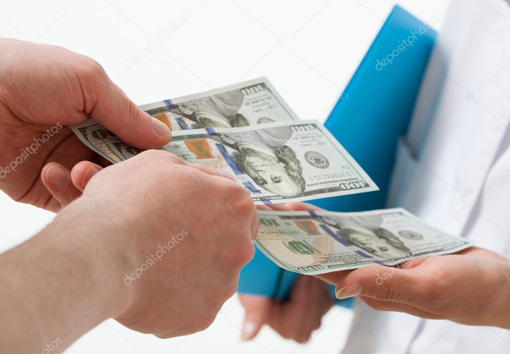 Patient's hand giving a bribe doctor